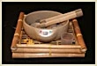 Singing bowl and mallet on a bamboo tray
