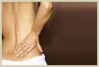 Woman holding her lower back in pain, sports injury and back pain laser therapy