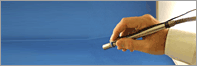 Hand holding a pen-style therapy device, therapeutic laser session in Orange County